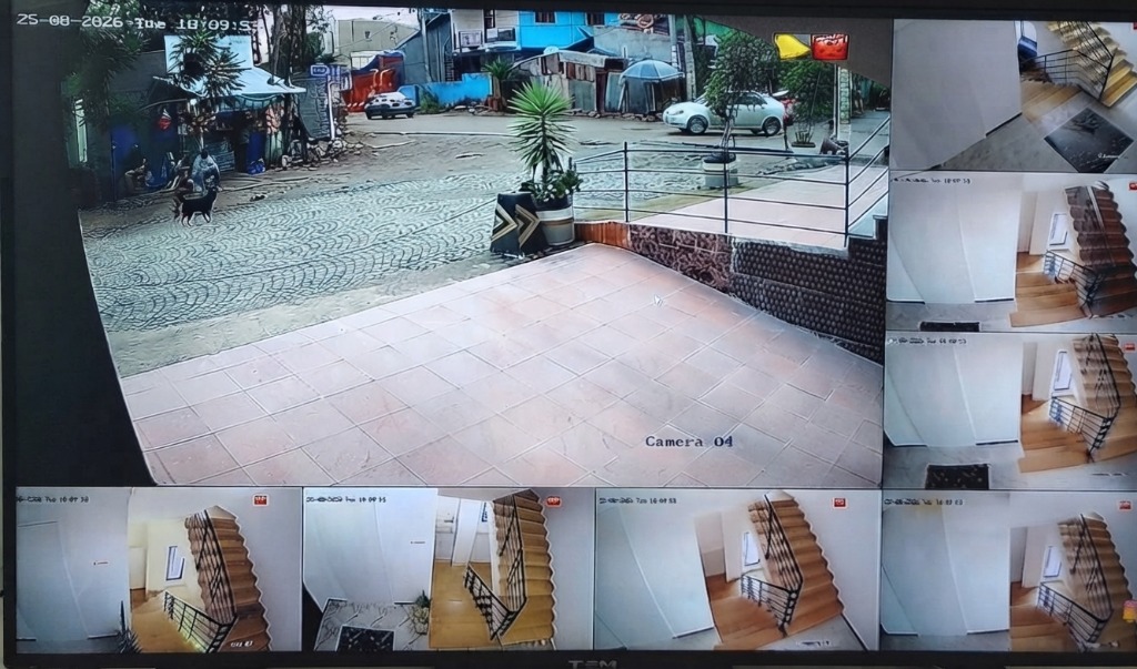 24/7 CCTV security camera monitoring station covering guesthouse compound, entrance and stairwells